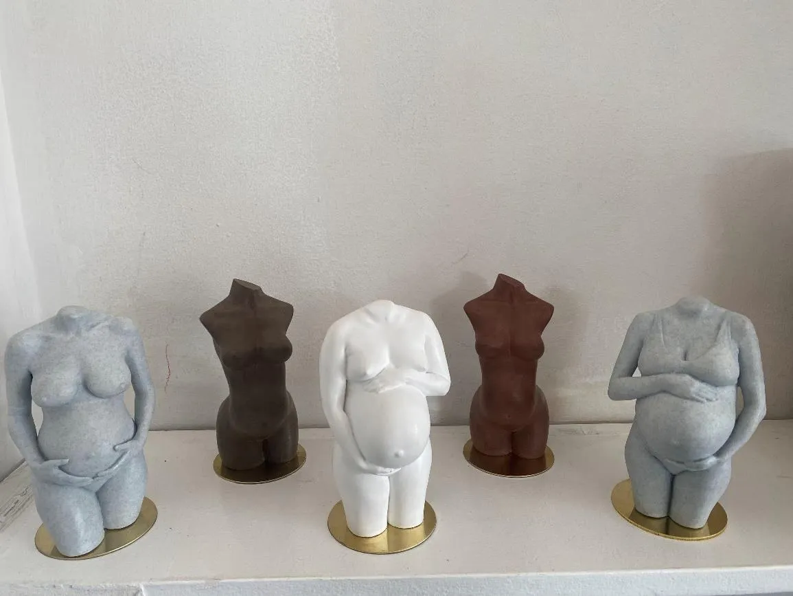 Five finished pregnancy sculptures in different poses and finishes